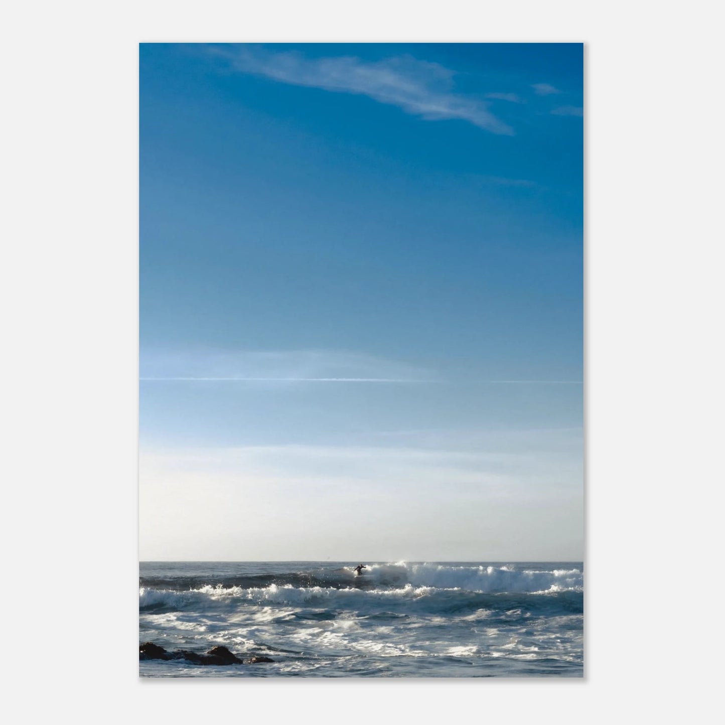 This minimalist lake photography print features a serene blue-toned landscape with soft mountain views and subtle human presence, making it ideal for calm wall art, modern coastal decor, and minimalist interior design. Perfect for living rooms and bedrooms, this fine art print blends tranquility with gentle movement through soft blue hues and balanced composition.