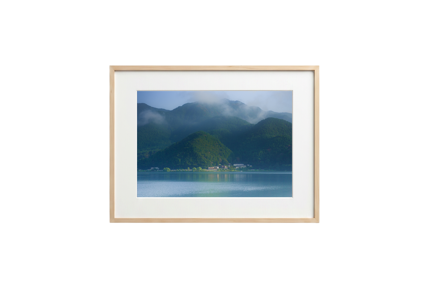 Framed photograph of a mountain landscape with a lake on a black background