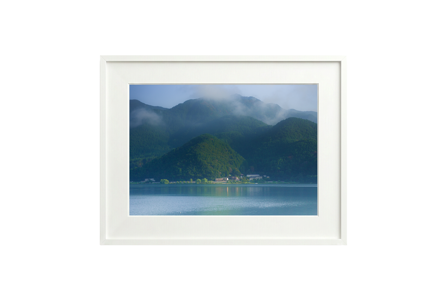 Framed artwork of a mountain landscape with a lake.