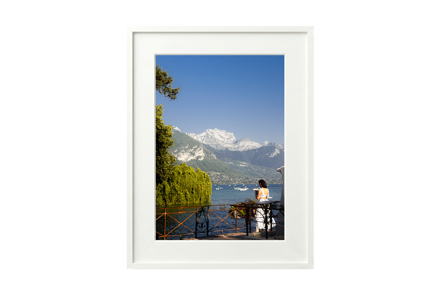 Framed photograph of a scenic view with mountains and a lake.