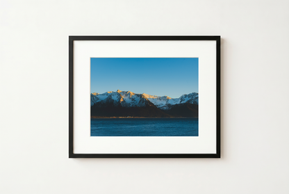 Framed photograph of a mountain landscape with a blue sky.