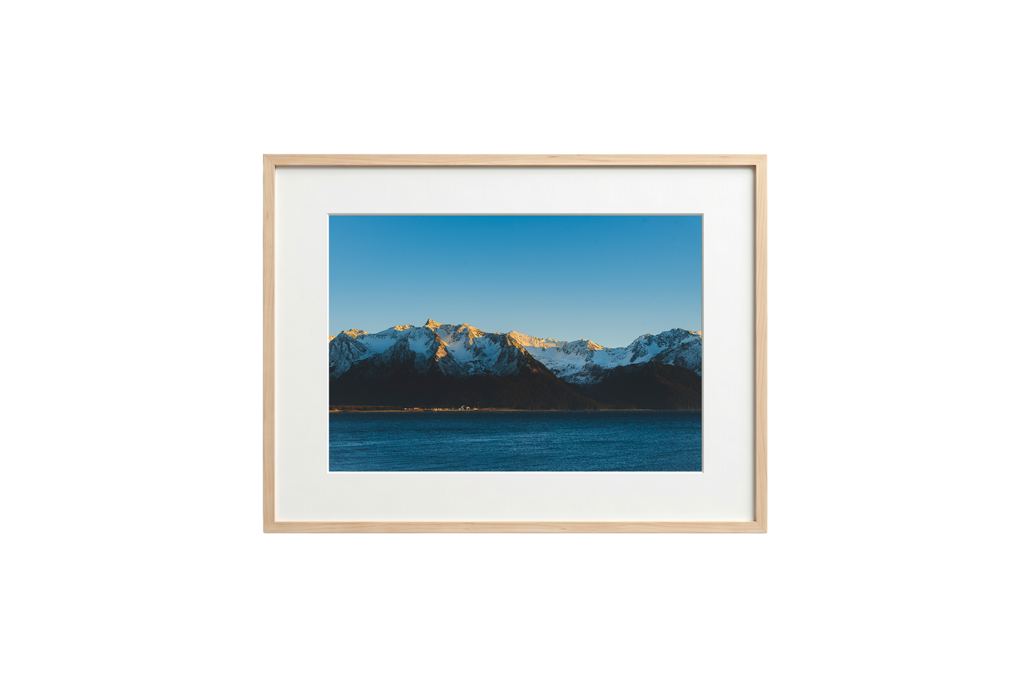 Framed photograph of a mountain landscape with a blue sky.