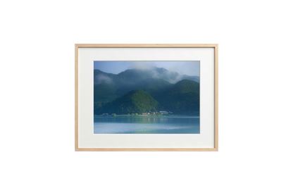Framed photograph of a mountain landscape with a lake.