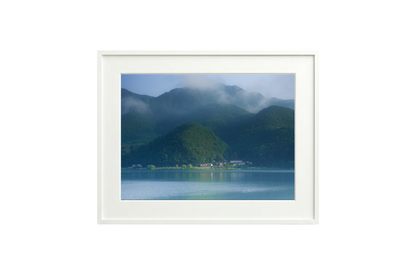 Framed photograph of a mountain landscape with a lake.