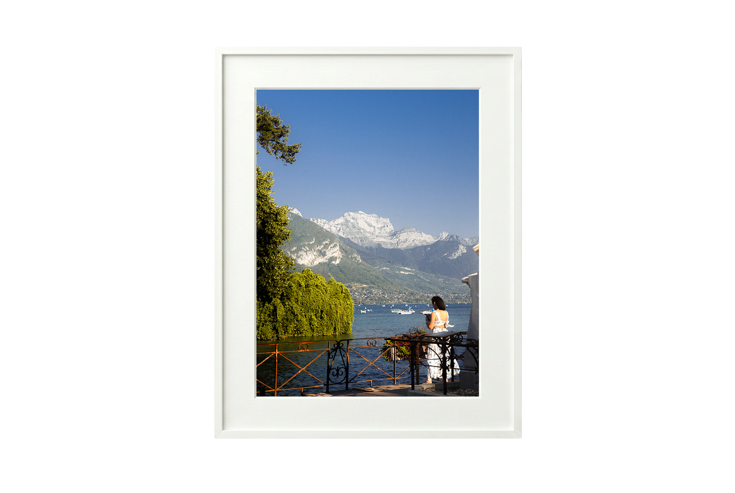 Framed photograph of a scenic view with mountains and a lake.