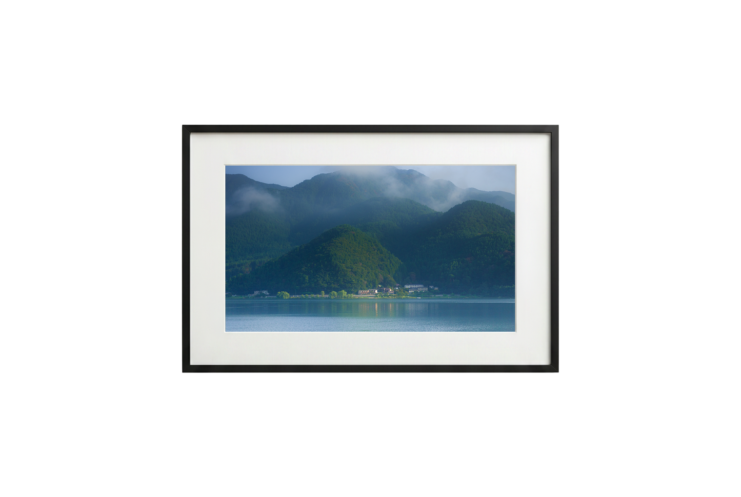 Framed photograph of a mountain landscape with a lake.