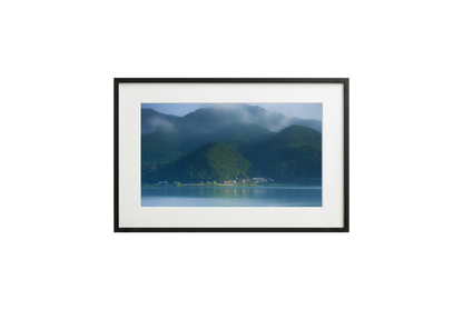 Framed photograph of a mountain landscape with a lake.