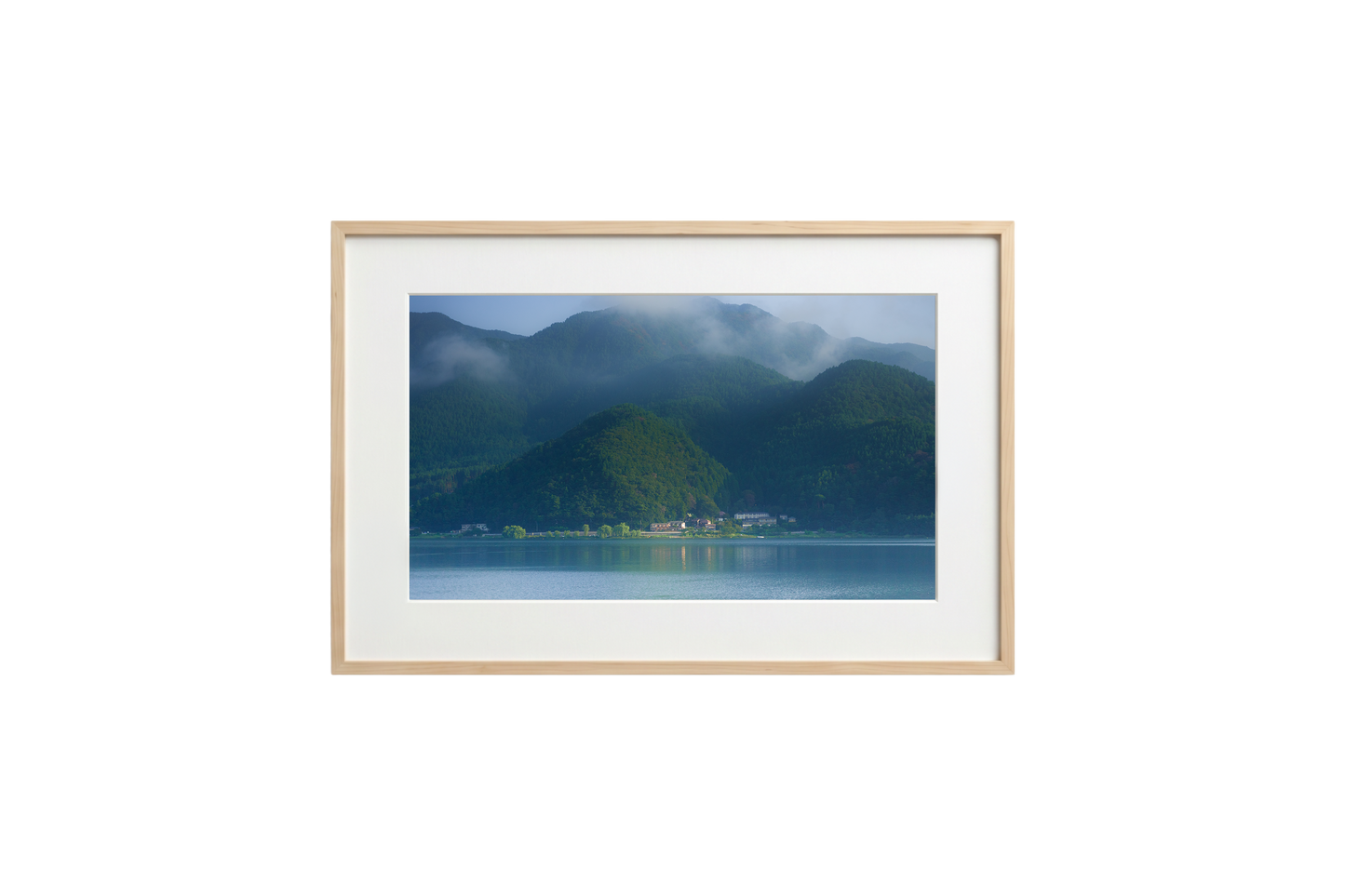 Framed photograph of a mountainous landscape with a lake.