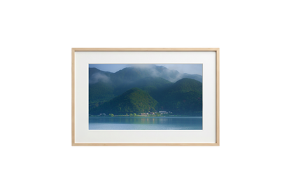 Framed photograph of a mountainous landscape with a lake.