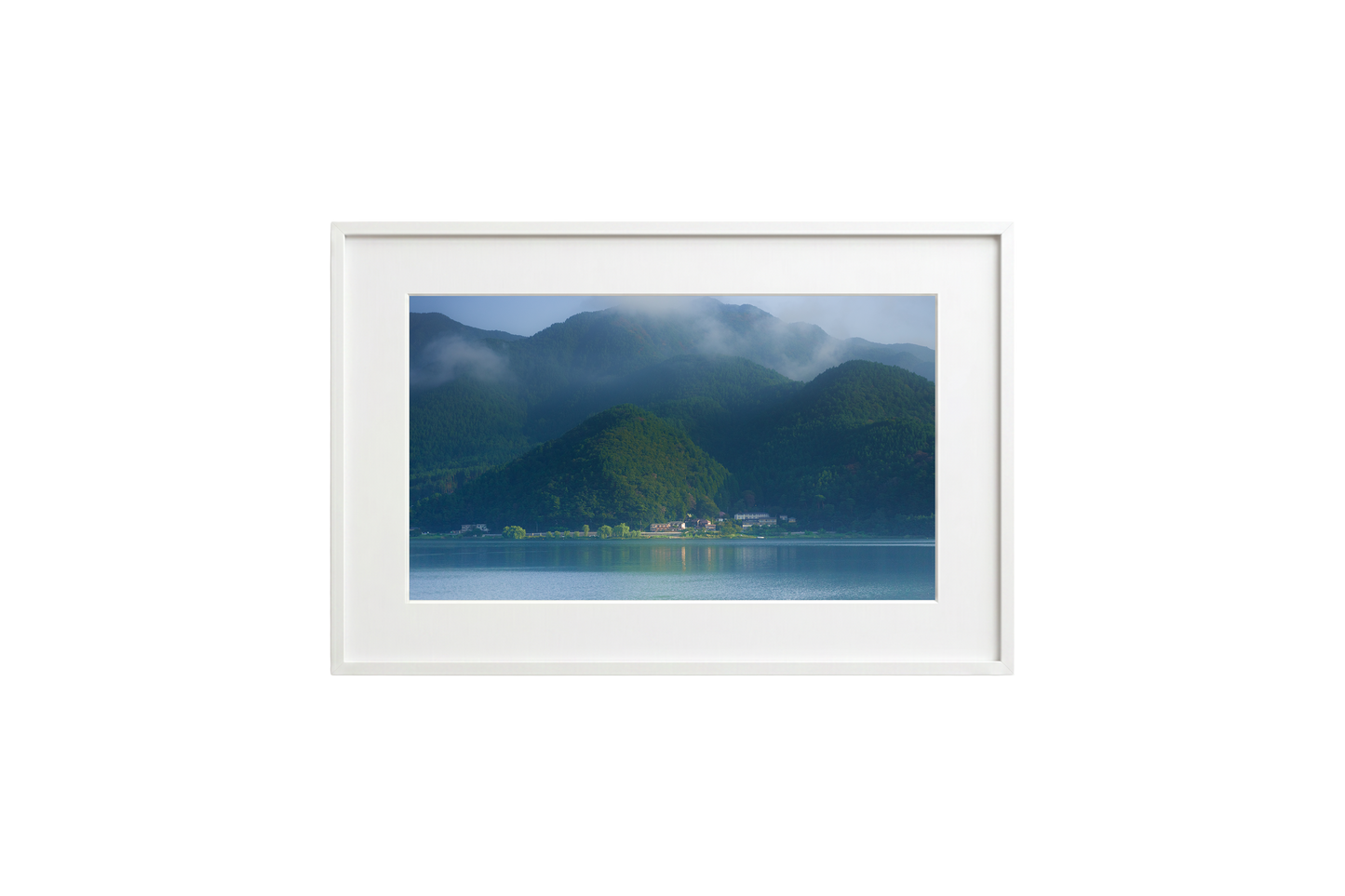 Framed photograph of a mountain landscape with a lake.