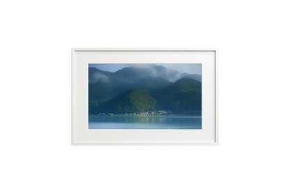 Framed photograph of a mountain landscape with a lake.