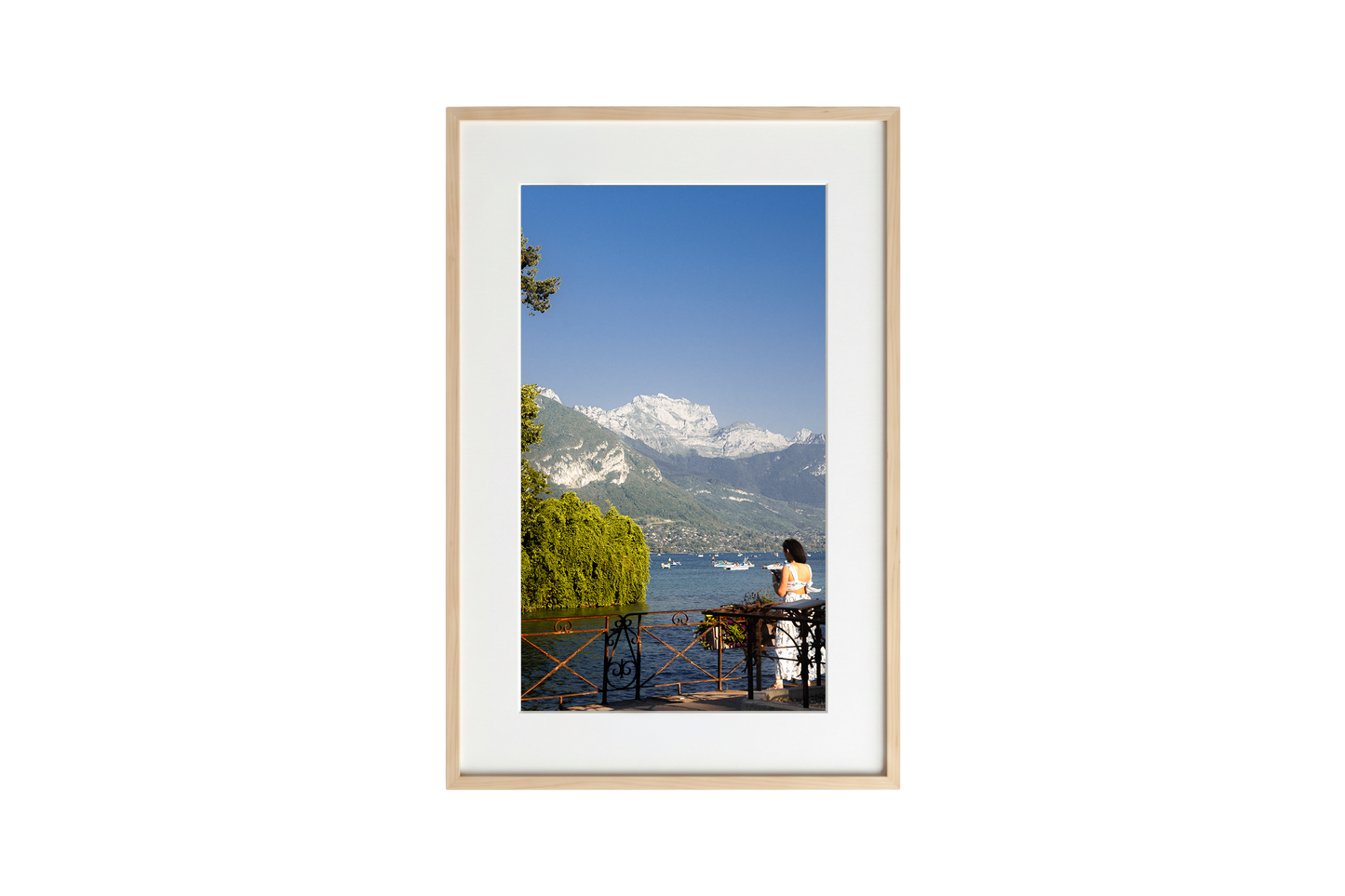 Framed photograph of a scenic view with mountains and a lake.