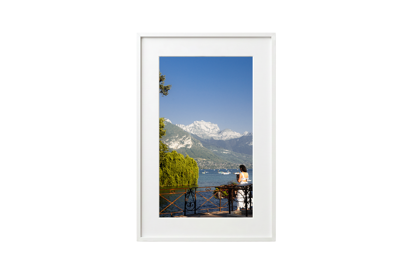 Framed photograph of a scenic view with mountains and a lake.