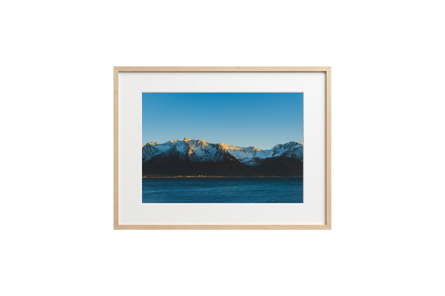 Framed photograph of a mountain landscape with a blue sky.