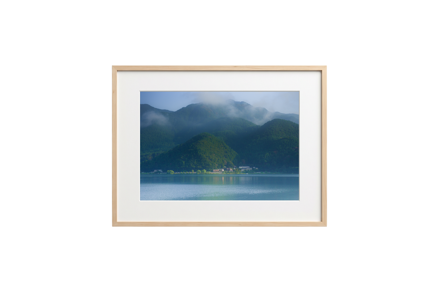 Framed photograph of a mountain landscape with a lake on a black background
