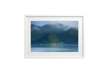 Framed photograph of a mountain landscape with a lake.