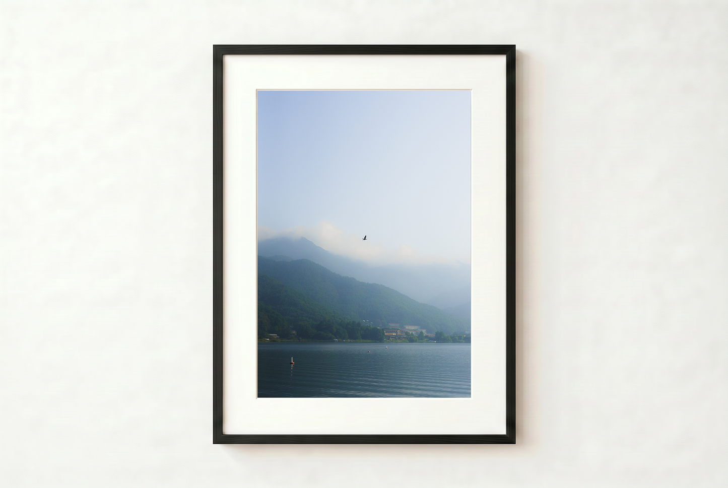 minimalist mountain lake photography print features a serene blue-toned landscape