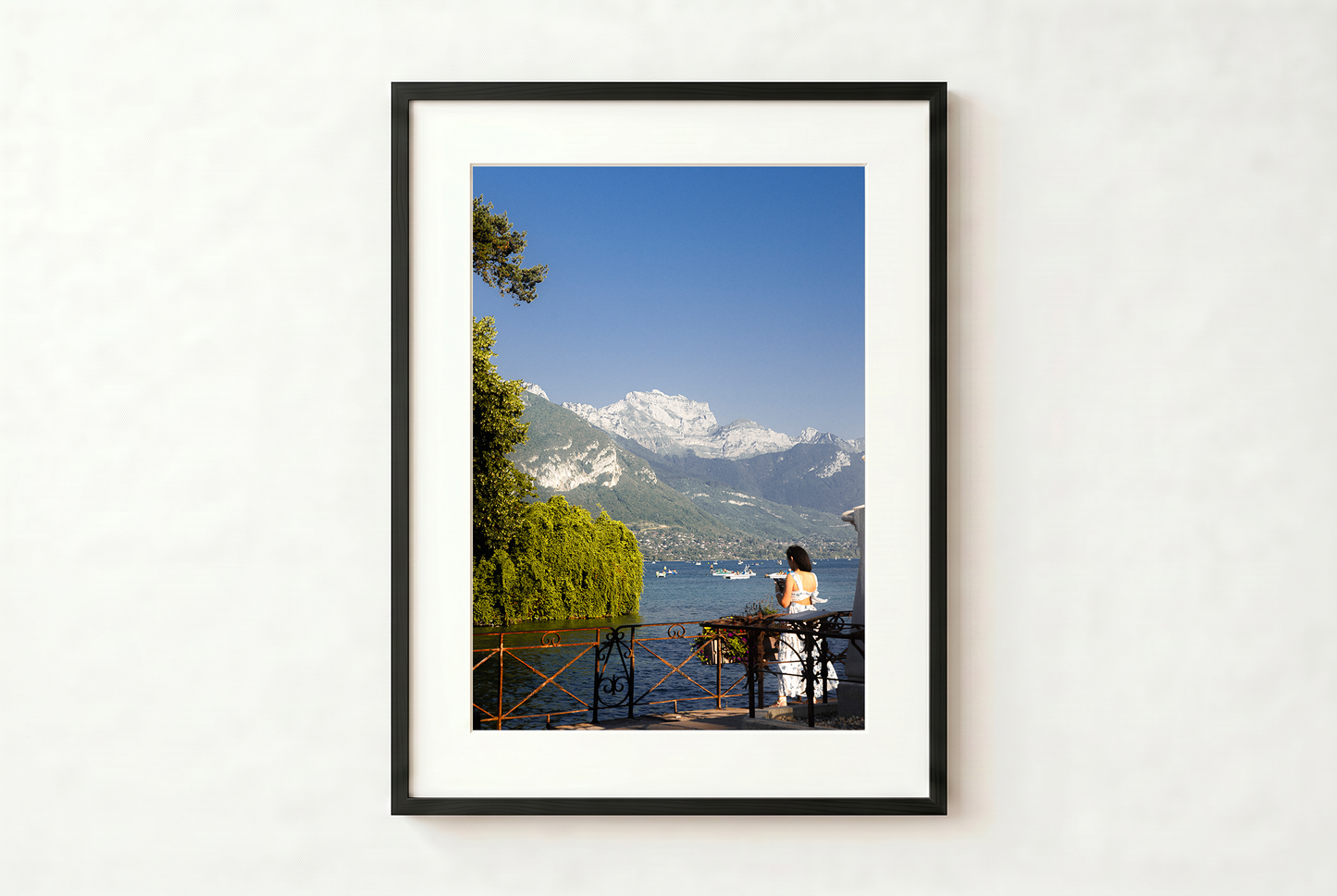 Framed photograph of a scenic view with mountains and a lake.