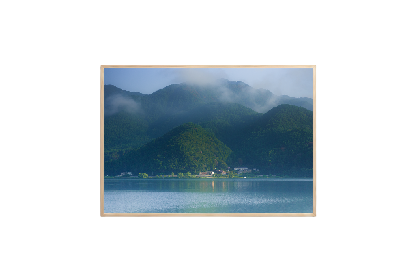 Scenic view of mountains and a lake with a wooden frame.