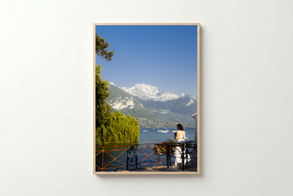 Framed photograph of a scenic view with mountains and a lake.