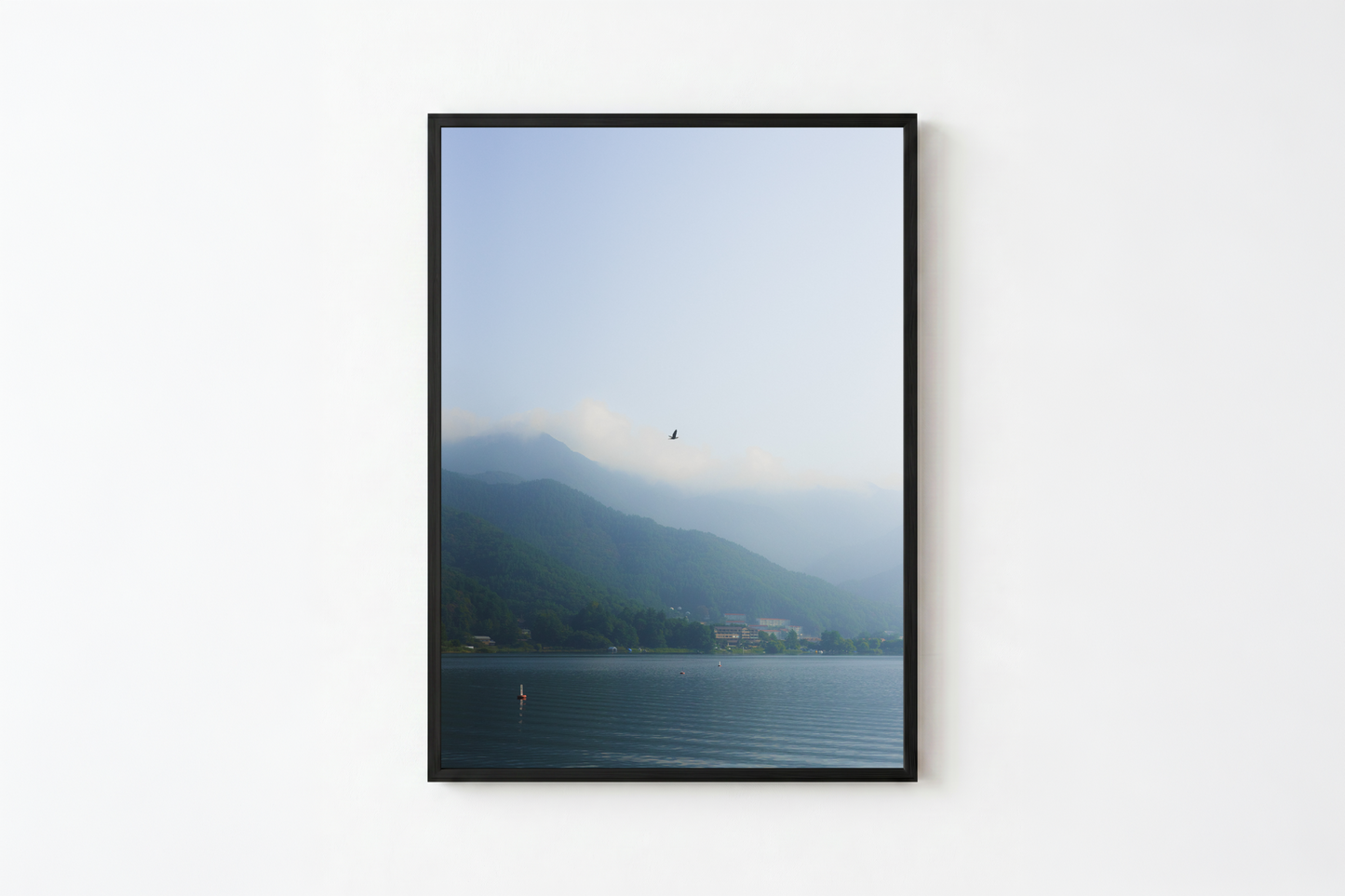 minimalist mountain lake photography print features a serene blue-toned landscape