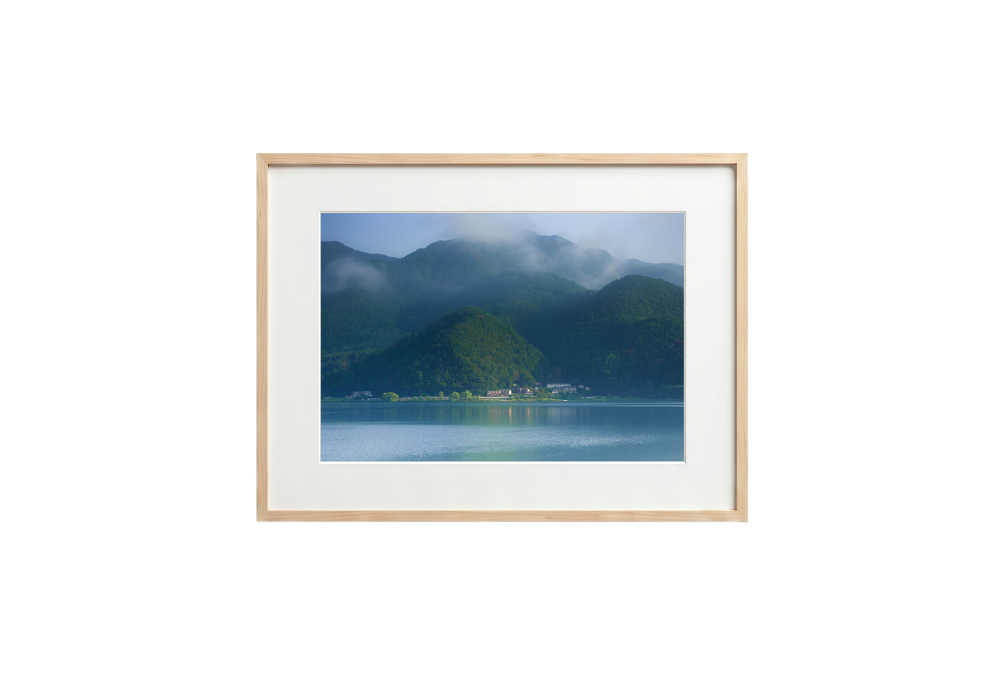 Framed photograph of a mountain landscape with a lake on a black background