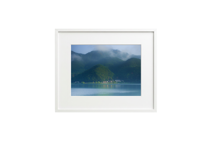 Framed photograph of a mountain landscape with a lake.