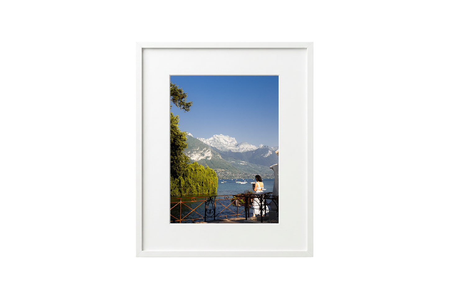 Framed photograph of a scenic view with mountains and a lake.