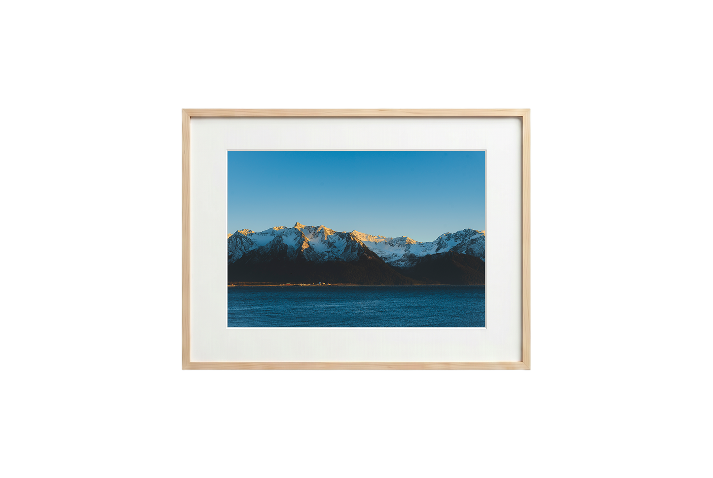 Framed photograph of a mountain landscape with a blue sky.