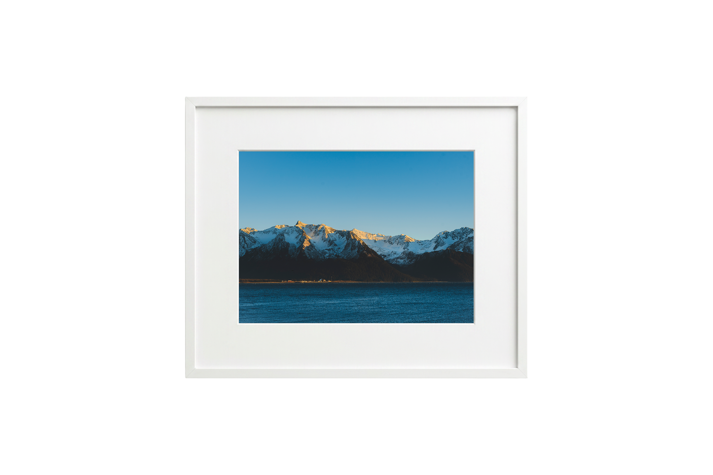 Framed photograph of a mountain landscape with a white frame.