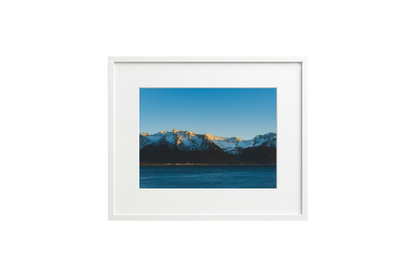 Framed photograph of a mountain landscape with a white frame.