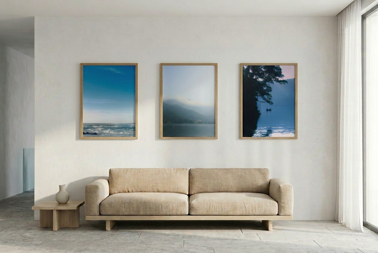 Beige sofa in a modern living room with three framed artworks on the wall.
This minimalist mountain lake photography print features a serene blue-toned landscape with a bird in flight, making it ideal for calm wall art, Japandi decor, and modern minimalist interiors. Perfect for living rooms, bedrooms, and offices, this fine art print enhances spaces with soft blue hues, atmospheric depth, and a peaceful, elevated aesthetic.
