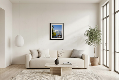 This alpine lake wall art print features serene blue tones, mountain landscapes, and a peaceful waterside setting, making it ideal for minimalist and modern interiors. Inspired by European lakeside scenery, this fine art photography print brings calm, light, and openness into your home. Perfect for those seeking tranquil wall art, mountain lake decor, or serene nature photography for living rooms and bedrooms