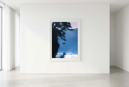 This minimalist lake photography print features a serene blue-toned landscape with a boat silhouette, making it perfect for calm wall art, Japandi decor, and modern minimalist interiors. Ideal for bedrooms, living rooms, and offices, this premium fine art print brings a peaceful, reflective atmosphere through soft blue hues and natural composition.