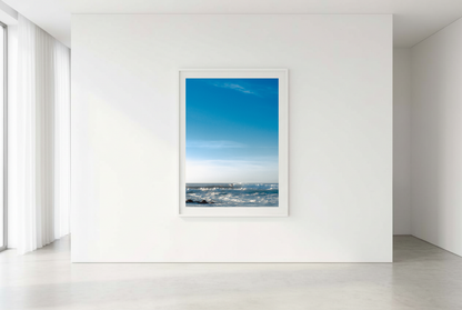 This minimalist ocean photography print features a serene blue seascape with a distant surfer, making it ideal for coastal wall art, calm interior design, and modern minimalist decor. Designed for those seeking premium fine art prints with soft blue tones, it enhances living rooms, bedrooms, and office spaces with a sense of tranquility and refined simplicity.