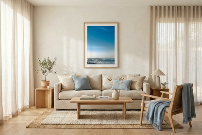 This minimalist ocean photography print features a serene blue seascape with a distant surfer, making it ideal for coastal wall art, calm interior design, and modern minimalist decor. Designed for those seeking premium fine art prints with soft blue tones, it enhances living rooms, bedrooms, and office spaces with a sense of tranquility and refined simplicity.