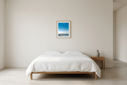 This minimalist ocean photography print features a serene blue seascape with a distant surfer, making it ideal for coastal wall art, calm interior design, and modern minimalist decor. Designed for those seeking premium fine art prints with soft blue tones, it enhances living rooms, bedrooms, and office spaces with a sense of tranquility and refined simplicity.