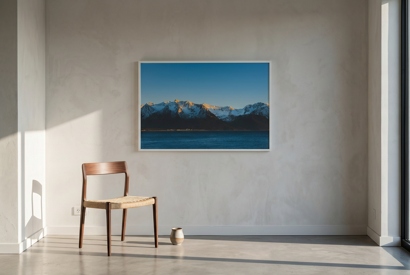 Wooden chair in a room with a large calming blue fine art photography on the wall.