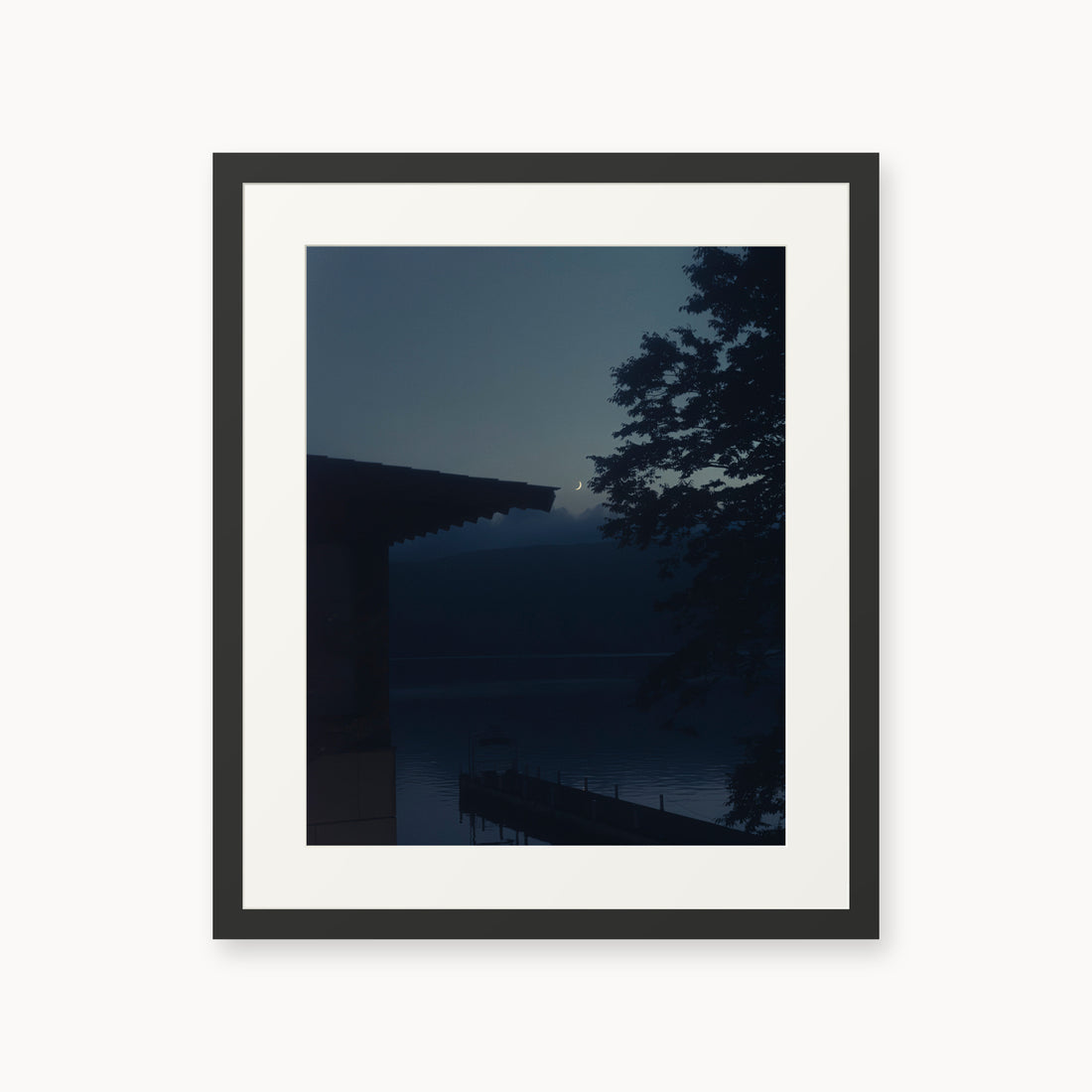 
A Daimyo’s Night — 16x20, black frame. Moon beside a dark roofline and leafy branches reflected in still water.