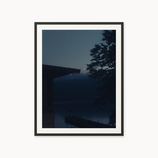 
A Daimyo’s Night — 30x40, black frame. Moon beside a dark roofline and leafy branches reflected in still water.
