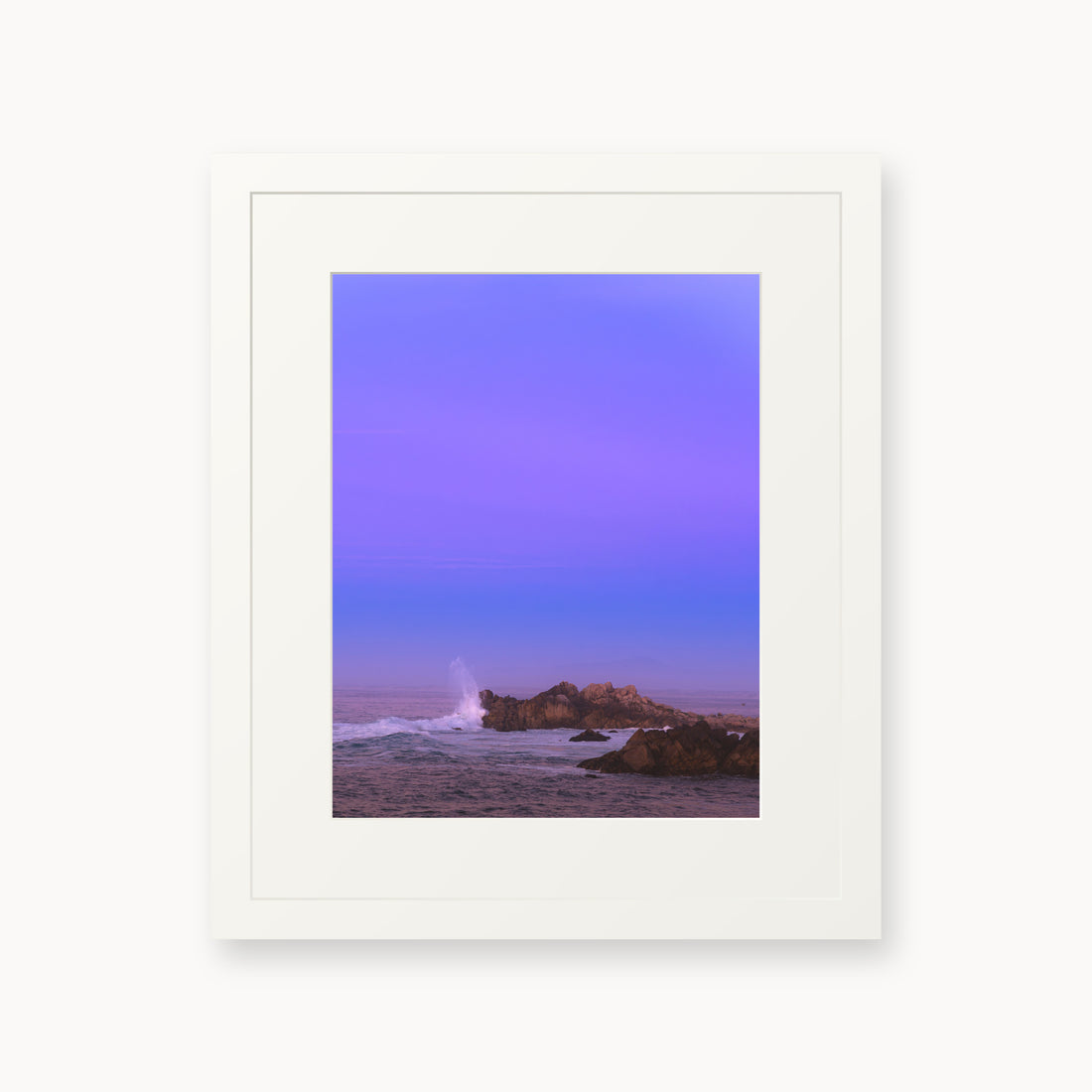 
Bonbon Beach — 11x14, white frame. A breaking wave and rocky shoreline beneath a broad violet sky.