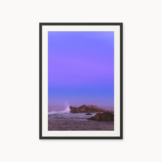 
Bonbon Beach — 24x36, black frame. A breaking wave and rocky shoreline beneath a broad violet sky.