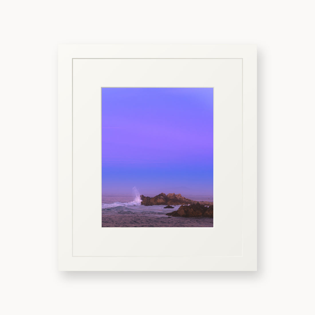 
Bonbon Beach — 8x10, white frame. A breaking wave and rocky shoreline beneath a broad violet sky.