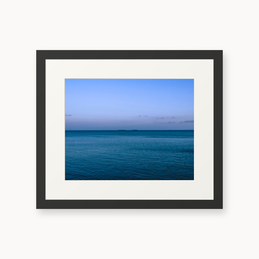 
Deux Bateaux Passants — 11x14, black frame. Two distant vessels along the horizon above a calm blue sea.
