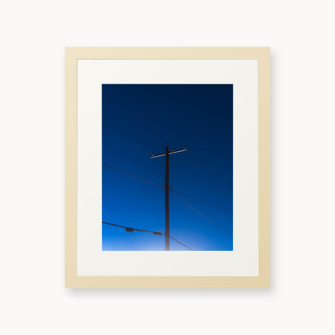 
Power — 11x14, maple frame. A utility pole and crossing wires against a saturated blue evening sky.