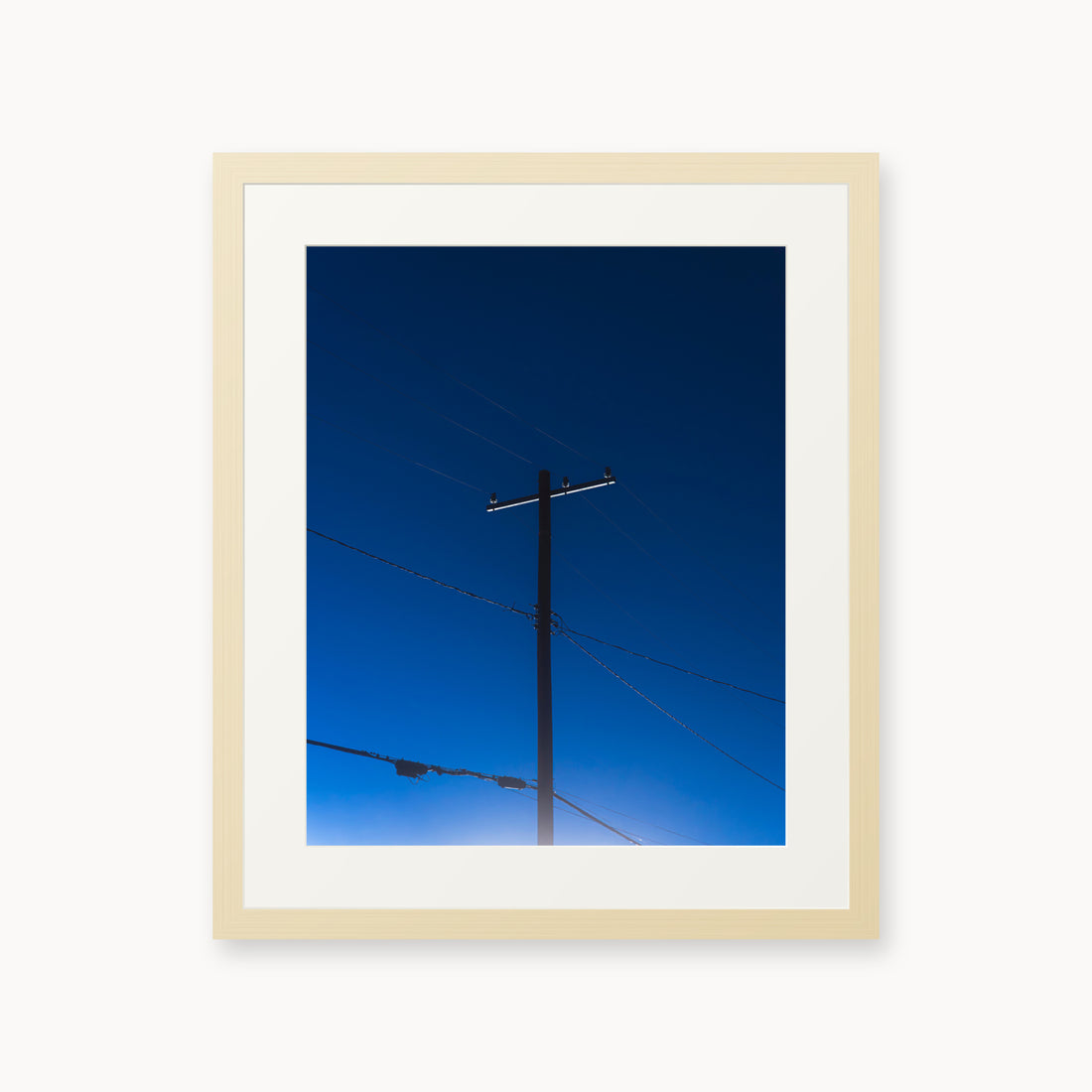 
Power — 16x20, maple frame. A utility pole and crossing wires against a saturated blue evening sky.