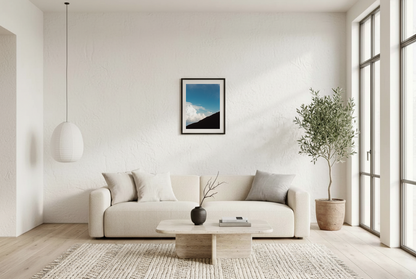 This minimalist mountain wall art features a blue sky landscape with a subtle human silhouette, creating a calm and reflective atmosphere. Perfect for modern and Scandinavian interiors, it adds depth and quiet elegance to any room.