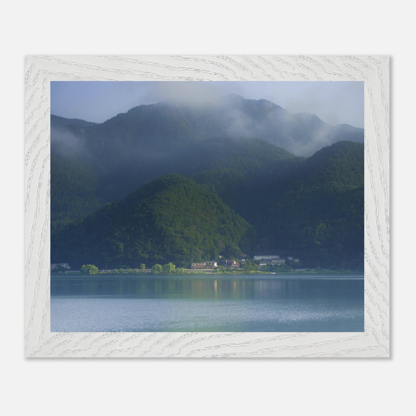 This misty lake mountain landscape wall art print captures serene blue tones and tranquil natural scenery, making it ideal for minimalist home decor. Designed for calming interiors, this fine art nature photography print enhances spaces with peaceful lake reflections, foggy mountain layers, and soft atmospheric light. A perfect choice for those seeking calming wall art, nature-inspired decor, or serene landscape prints for modern homes.