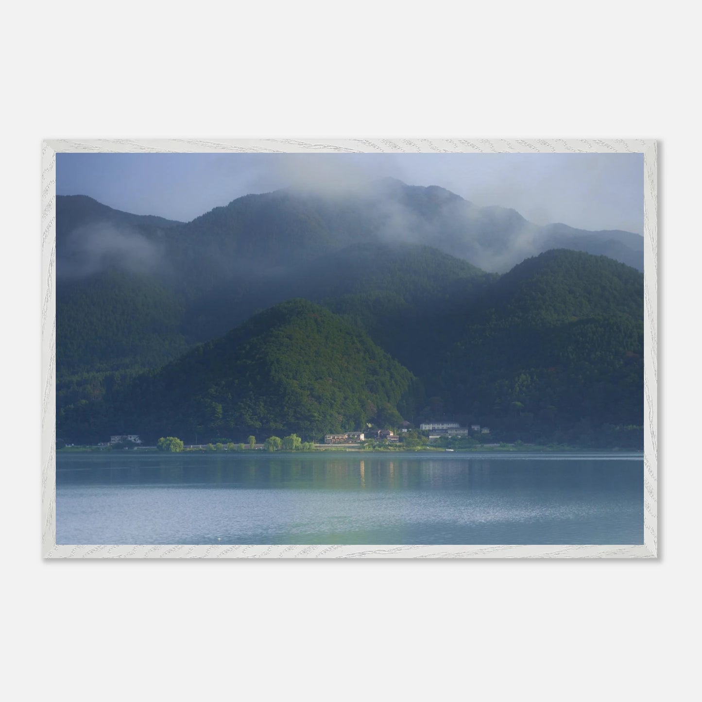 This misty lake mountain landscape wall art print captures serene blue tones and tranquil natural scenery, making it ideal for minimalist home decor. Designed for calming interiors, this fine art nature photography print enhances spaces with peaceful lake reflections, foggy mountain layers, and soft atmospheric light. A perfect choice for those seeking calming wall art, nature-inspired decor, or serene landscape prints for modern homes.