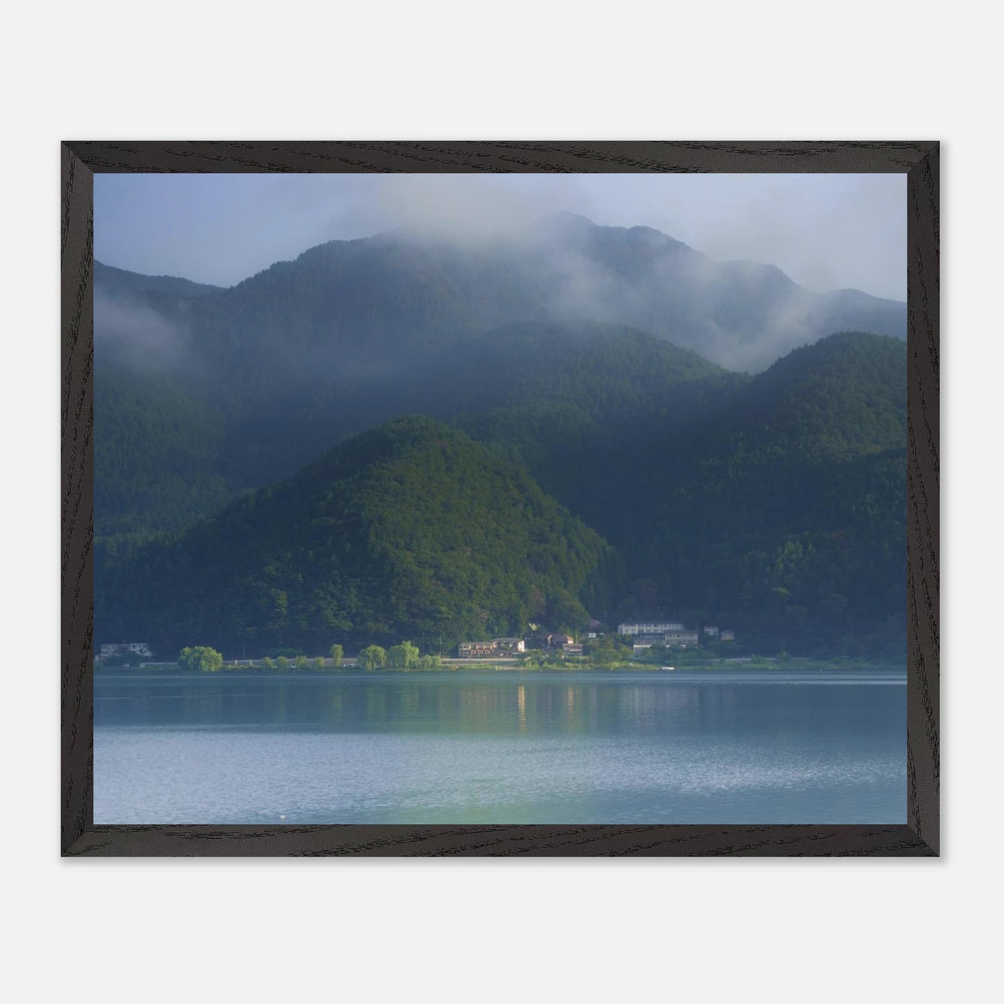 This misty lake mountain landscape wall art print captures serene blue tones and tranquil natural scenery, making it ideal for minimalist home decor. Designed for calming interiors, this fine art nature photography print enhances spaces with peaceful lake reflections, foggy mountain layers, and soft atmospheric light. A perfect choice for those seeking calming wall art, nature-inspired decor, or serene landscape prints for modern homes.